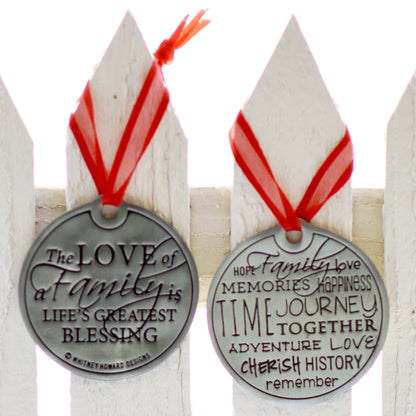 The Love of a Family is Life's Greatest Blessing Holiday Ornament front and back hanging on a fence